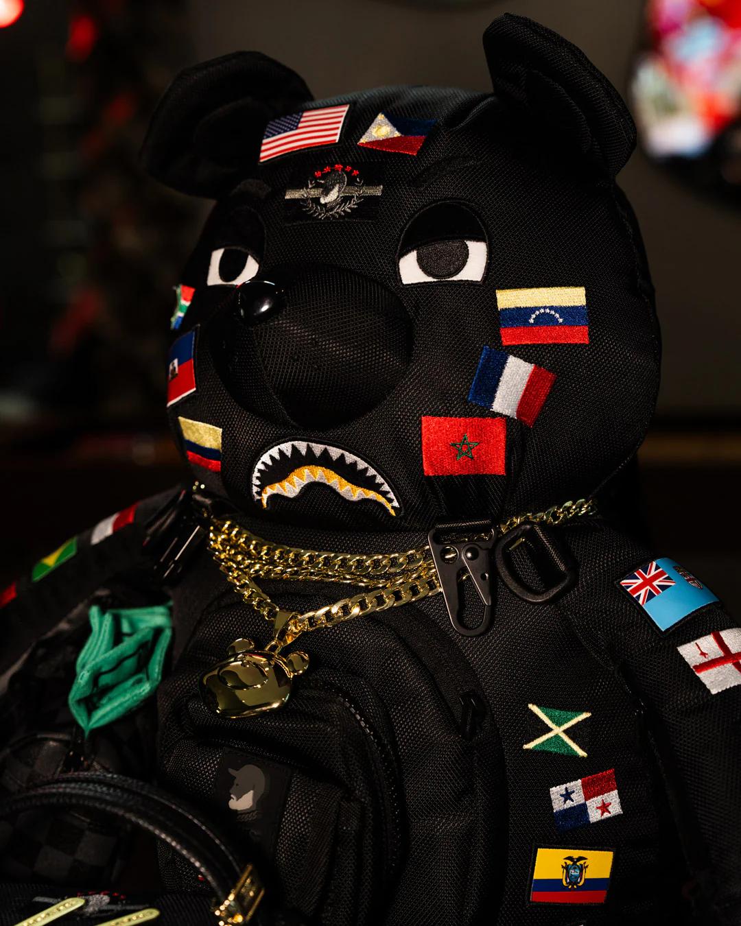 JAMES FIRST CLASS GLOBAL FLAGS MONEYBEAR BACKPACK | Sprayground Value