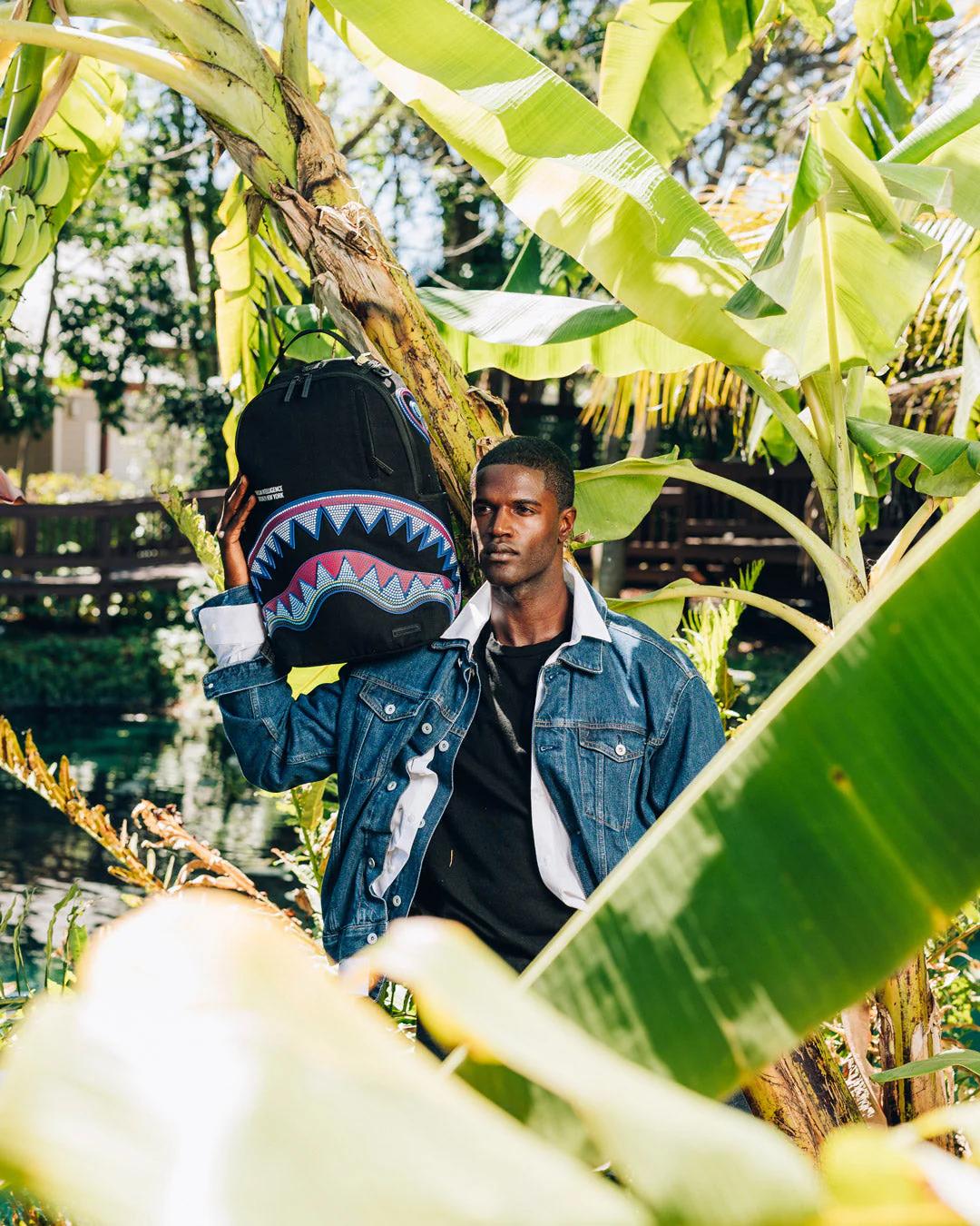 A.I. AFRICAN INTELLIGENCE BORN AND RAISED BACKPACK - SANDFLOWER COLLAB | Sprayground Signature