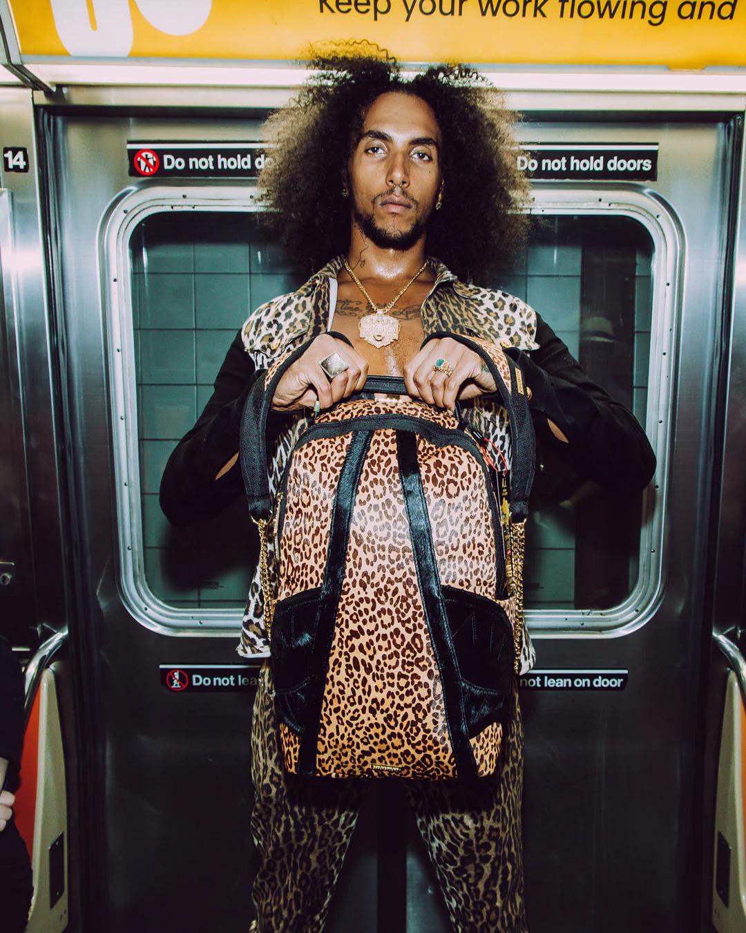 AFRICAN INTELLIGENCE 9 COURAGE LIVES ON BACKPACK - SANDFLOWER COLLAB | Sprayground Quality