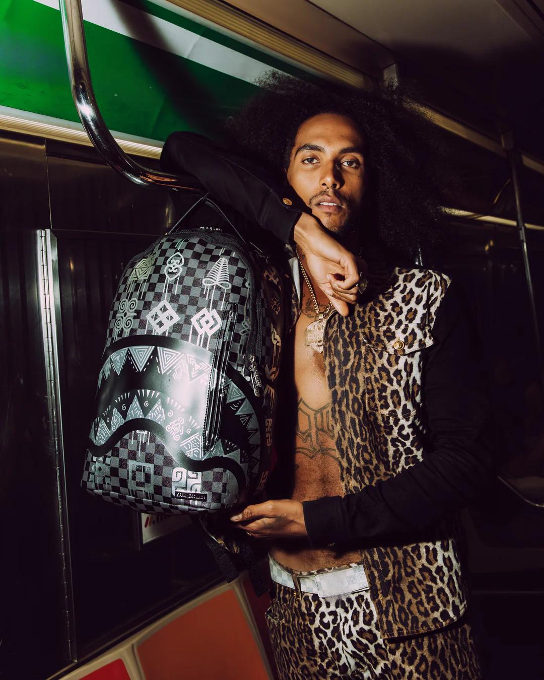 AFRICAN INTELLIGENCE 9 POWER GLYPHICS BACKPACK - SANDFLOWER COLLAB | Sprayground New