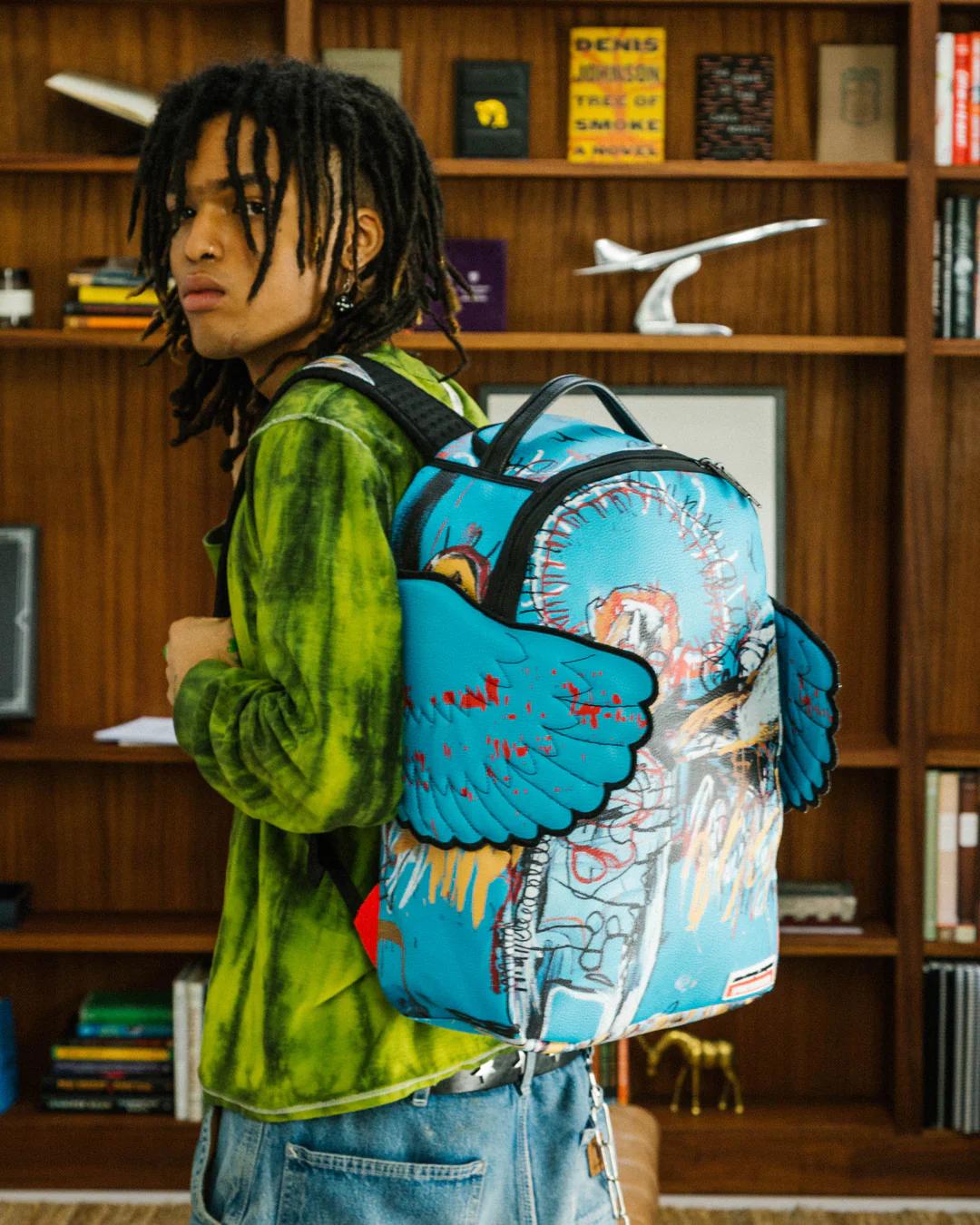 OFFICIAL BASQUIAT UNTITLED (FALLEN ANGEL) 1981 WING BACKPACK (DLXV) | Sprayground Best Seller